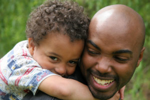 Happy african american dad with little curly headed son