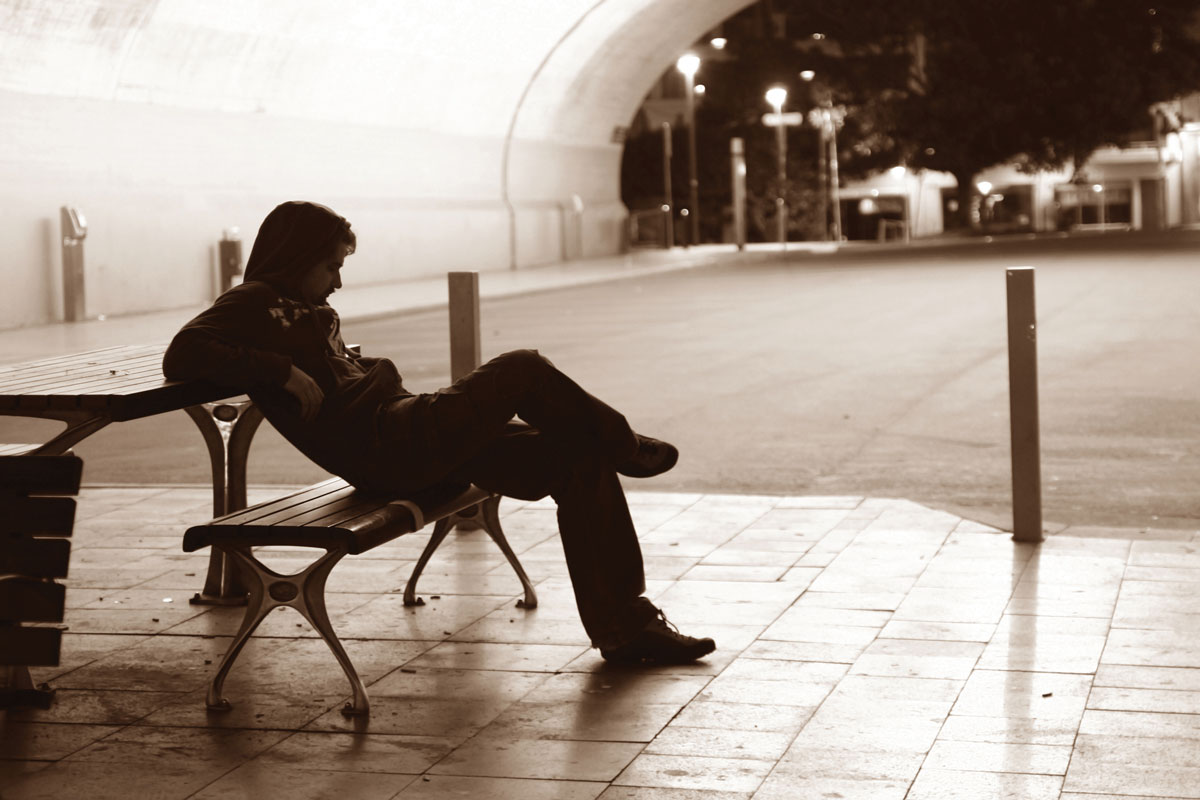 Man sitting alone on a bench
