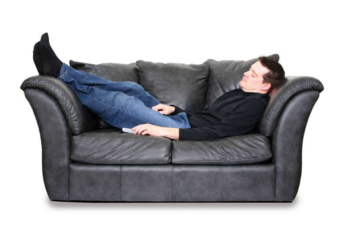 Young husband asleep on leather couch
