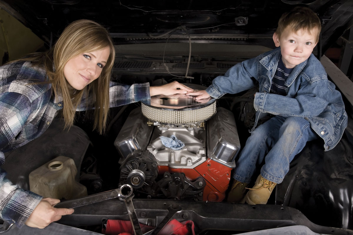 Mom and son working on car maintenance together