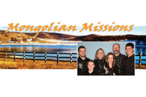 Missionary family picture in front of scenic picture taken in Mongolia