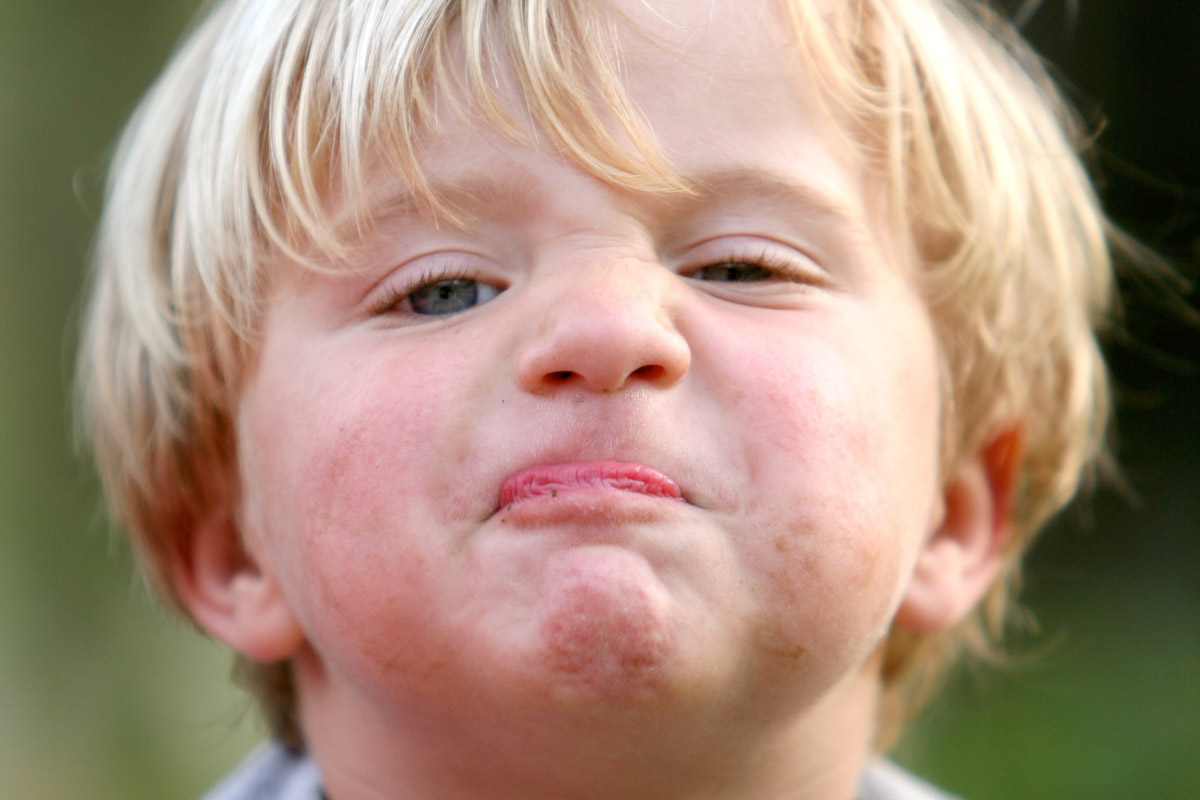 Young boy's face with stubborn expression