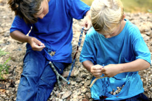 Boys making slingshots