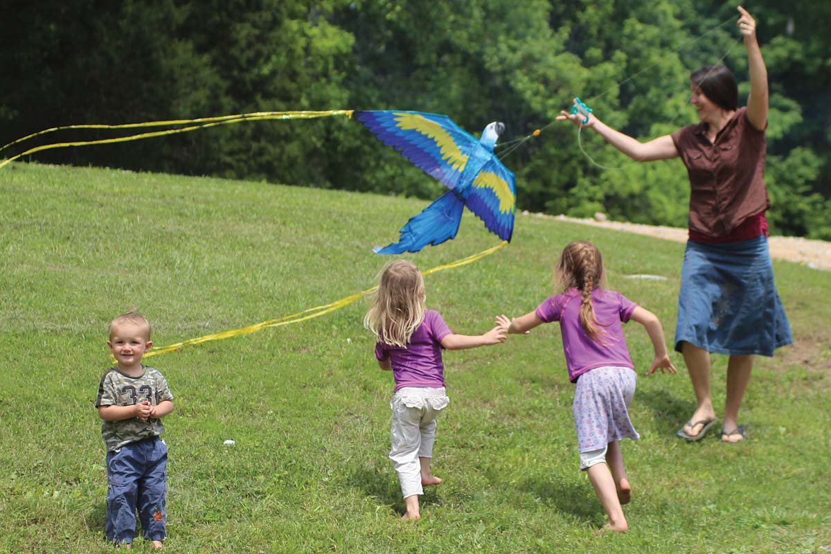 Mother and children flying a kite